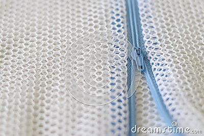 White mesh bag with blue zipper for washing machine. Stock Photo