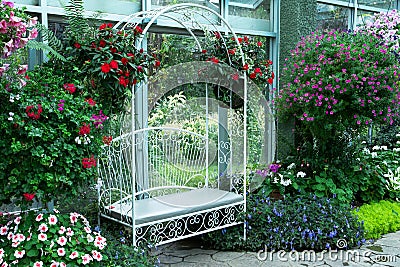 White metal arch bench in indoor park in the Royal flora public garden in Chiangmai, Stock Photo