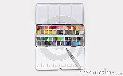 White metal box with watercolors, brush and palette on a light gray background Stock Photo