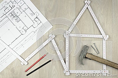 White meter tool forming a house and engineering tools on woode Stock Photo