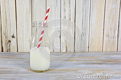 White milk in retro bottle with straw Stock Photo