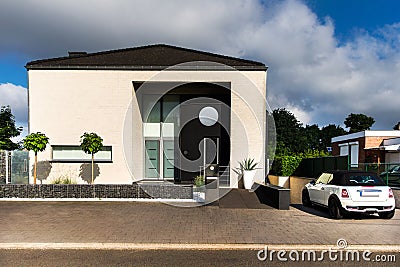 White Mini Cooper and a beautiful modern house Stock Photo