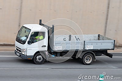 White Mitsubishi Fuso Canter truck driving along the Ronda Litoral in Barcelona Editorial Stock Photo