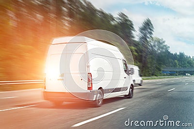 White modern delivery small shipment cargo courier van moving fast on motorway road to city urban suburb. Business distribution Stock Photo