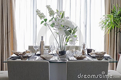 White modern dinning room with flower on table Stock Photo