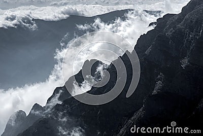 White mountain clouds above high peaks Stock Photo