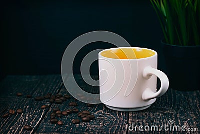 White mug and coffee zerg on an old textured wood table with a houseplant Stock Photo