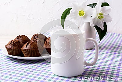 White mug mockup with chocolate muffins on plate Stock Photo