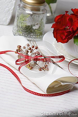 White napkin decorated with red ribbon Christmas plant, table se Stock Photo