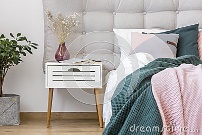 White nightstand in pastel bedroom Stock Photo