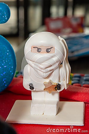 White ninja lego mini figure on birthday cake Editorial Stock Photo