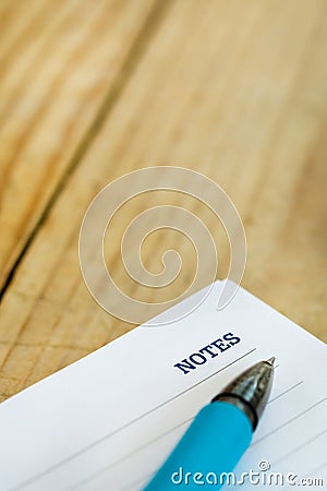 White note with notes word over rustic wooden background Stock Photo