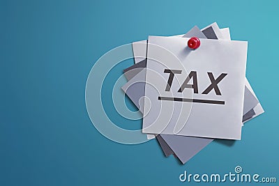 White note paper and written Tax for reminder Stock Photo