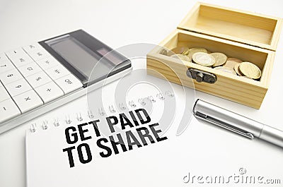 white notebook with the inscription - Get Paid to Share Stock Photo