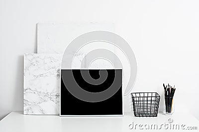 white office interior, stylish work table space with poster artw Stock Photo