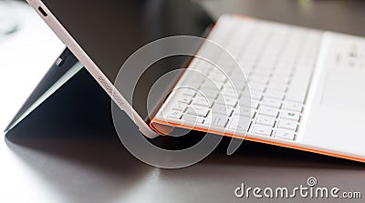 White orange convertible laptop and keyboard Stock Photo