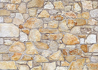 White and orange stone wall made of large flat natural rocks. Stock Photo