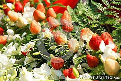White orchid flowers arranged with fresh strawberry Stock Photo