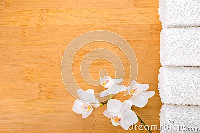 white orchid and white towels on the bamboo backgro Stock Photo