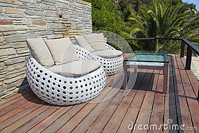 White outdoor furniture on wood resort terrace Stock Photo