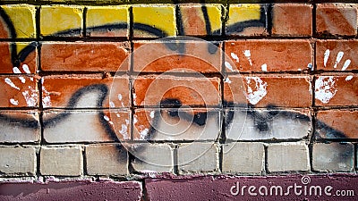 White paint prints of four hands on colourful graffity on a brick wall Stock Photo