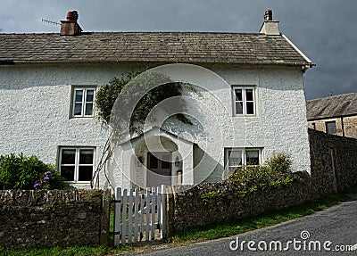 White painted English cottage with porch & garden gate Editorial Stock Photo