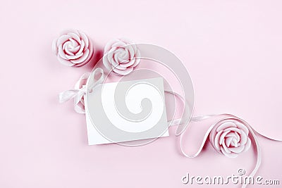 White paper card decorated with pink bow and rose scented candle Stock Photo