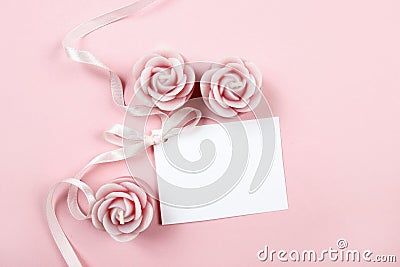 White paper card decorated with pink bow and rose scented candle Stock Photo