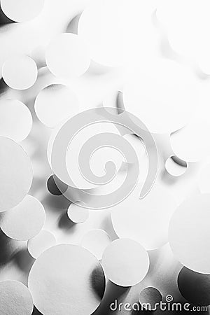 White paper circles as mess swarm random abstract pattern in shining hard light with contrast black strict shadows, reflection. Stock Photo