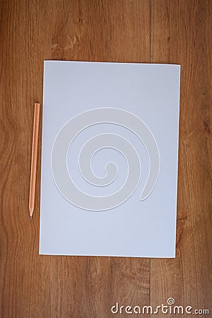 White paper and pencil on wood table Stock Photo