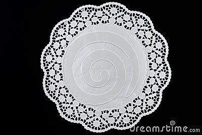 White paper round lace doily, on black background Stock Photo