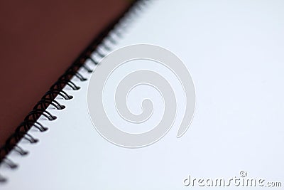 White paper spiral notebook on brown background Stock Photo