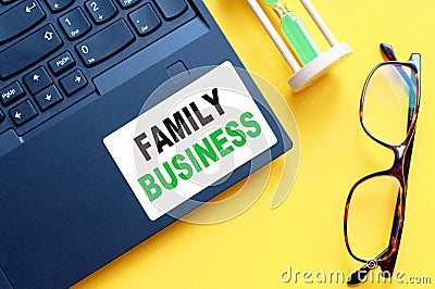White paper with text FAMILY BUSINESS in male hands on a white background Stock Photo