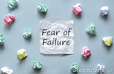 White paper with text Fear of Failure on the blue background with a lot of another paper Stock Photo