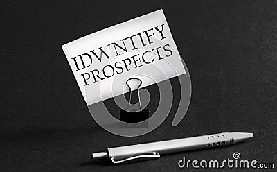White paper with text Identify Prospects on a black background with stationery Stock Photo