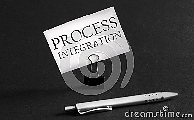 White paper with text Process Integration on a black background with stationery Stock Photo