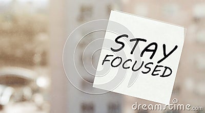 White paper with text Stay Focused on the window Stock Photo