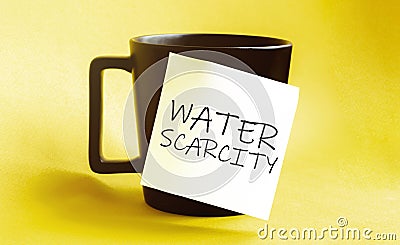 White paper with text Water scarcity on the black cup Stock Photo