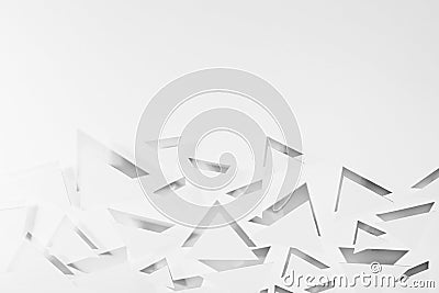 White paper triangles different size soar as abstract random pattern in bright light with grey shadows, reflection and glare. Stock Photo