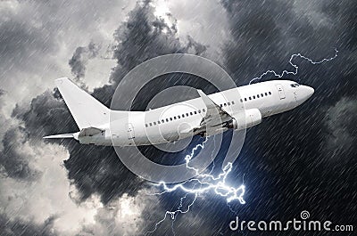 White passenger airplane takes off during a thunderstorm lightning strike of rain, bad weather. Stock Photo