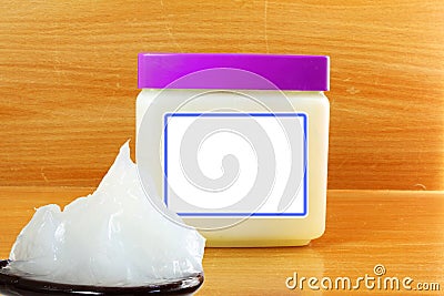 White petroleum jelly in spoon with jar Stock Photo