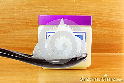 White petroleum jelly in spoon with jar Stock Photo