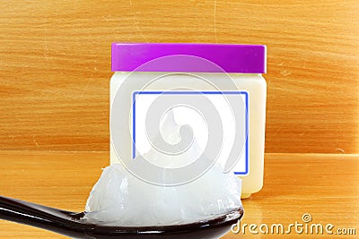 White petroleum jelly in spoon with jar Stock Photo