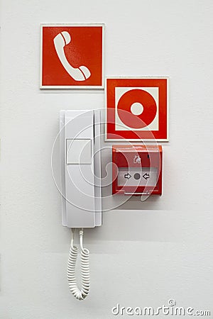 White phone , red fire button on the wall Editorial Stock Photo