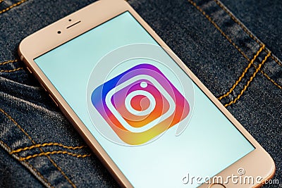 White phone with logo of social media Instagram on the screen. Social media icon. Editorial Stock Photo