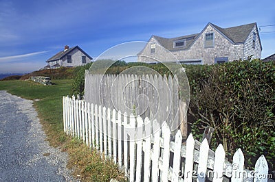 White picket fence along Route 77 in Sakonnet, RI Stock Photo