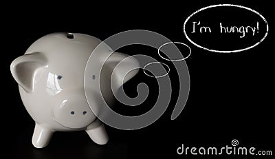 Piggy bank with thought bubbles, thinking I m hungry Stock Photo