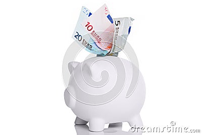 White piggy bank with Euros in the slot Stock Photo