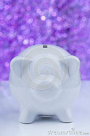 White piggy bank on purple background Stock Photo