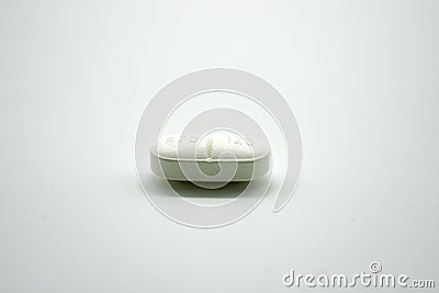 White pill on a light background, antibiotic amoxiclav Stock Photo